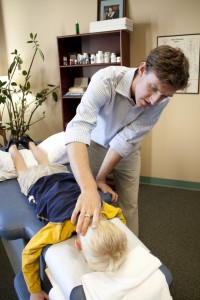 Treating child's upper cervical spine with DNFT Chiropractic in Salt Lake City, Utah Gentle adjustment, safe for all ages.