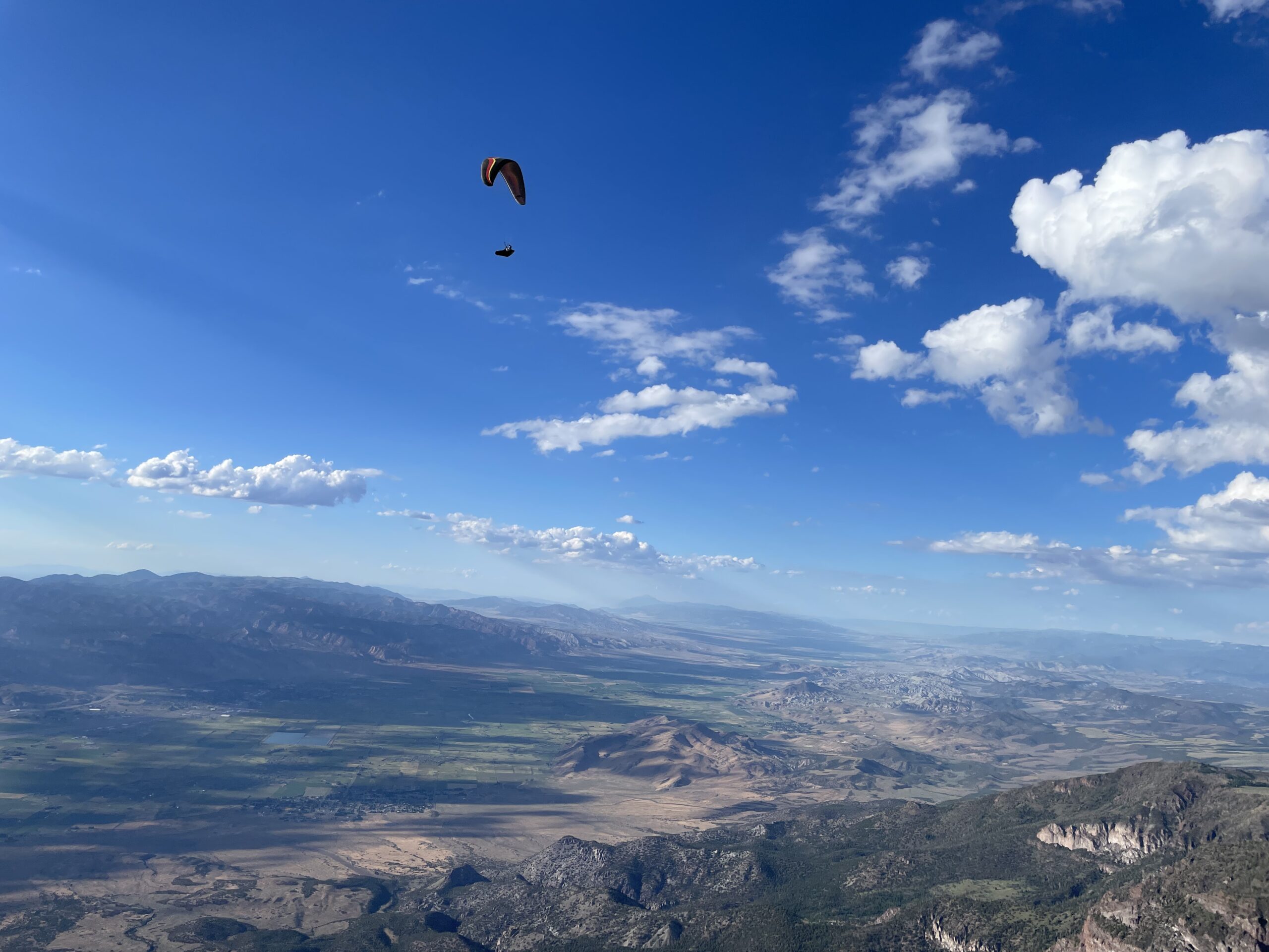 A paraglider canopy over the Sevier Valley near Cove