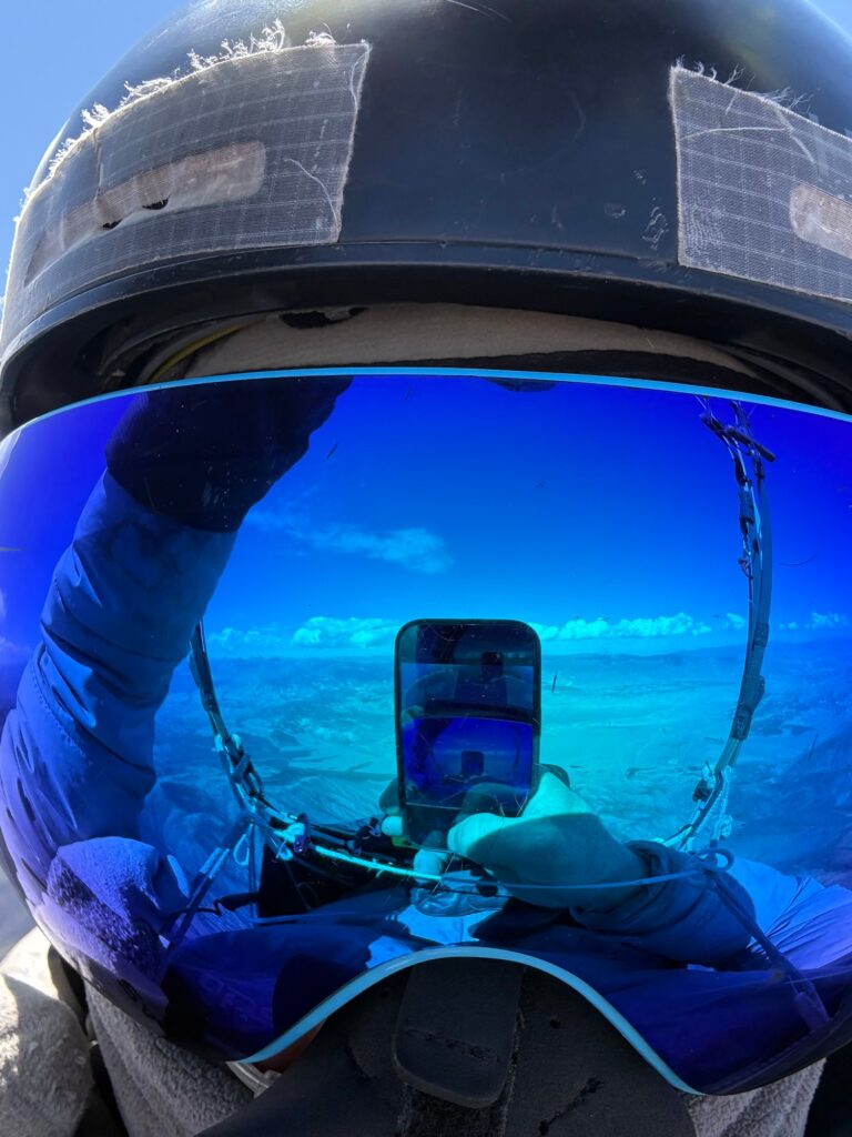 Jonathan Leusden in flight, the valley reflected in his visor